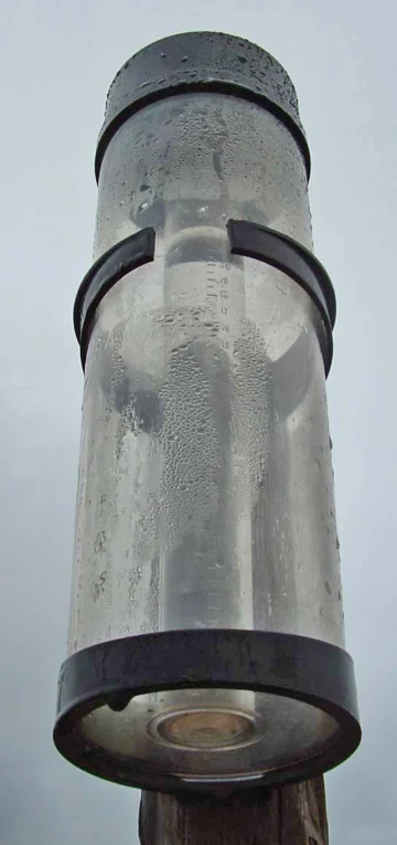 Rain gauge mounted outdoors.