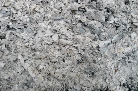 Grey wood ash and small charcoal fragments.