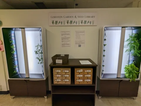 Two indoor growing towers beside a library cabinet.